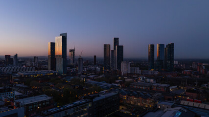 Twilight Manchester cityscape with illuminated skyscrapers