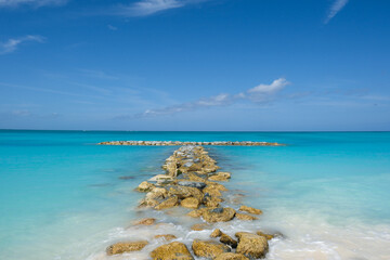 Rocks jet out into the turquoise water on an island in Turks and