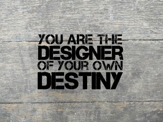 wooden background with motivational words You are the designer of your own destiny