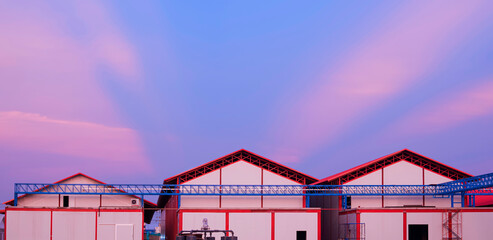 Row of industrial cold storage warehouse buildings structure with electrical cable ladder in...