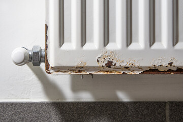 Corrosion on the metal surface of a heating radiator in a room