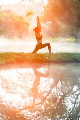 Healthy Yoga woman lifestyle balanced practicing meditate and energy yoga on the bridge in morning and sunset outdoors nature. Healthy life Concept