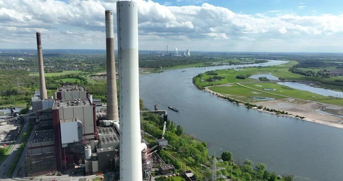 The Ruhr area is a highly industrialized region in the German state of North Rhine Westphalia. Here we see the rhine river and industrial powerplant. Aerial view.