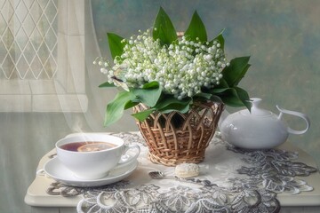Still life with bouquet  lily of the valley on a tea table