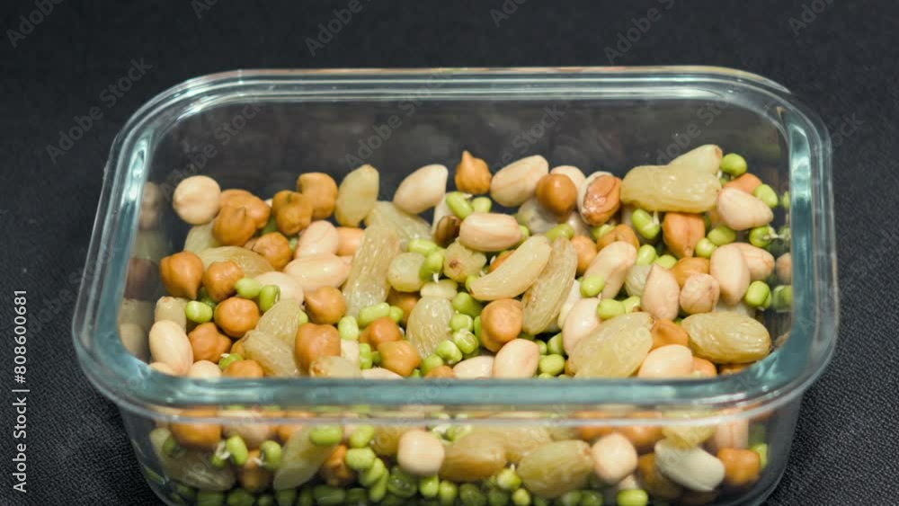 Poster taking soak sprouts and nuts from tifinbox closeup view