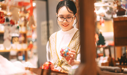 Asian woman choosing gift shop on Christmas and happy new year holidays