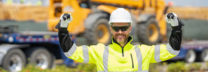 Man builder near excavator. Builder worker with excavator. Builder in helmet. Worker in hardhat....