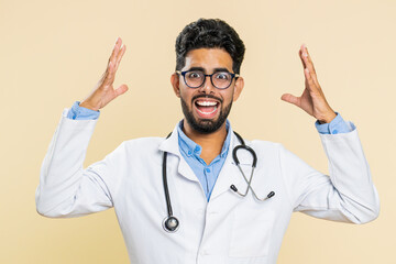 Irritated angry Indian young doctor cardiologist man screams from stress tension problems feels...