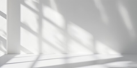 Minimalistic white room interior with sunlight casting soft shadows through window blinds