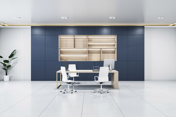 A modern office interior with a desk, swivel chairs, computer, and shelving against a blue paneled wall, concept of a workplace. 3D Rendering