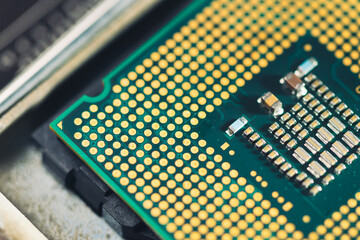 The technician is putting the CPU on the socket of the computer motherboard.