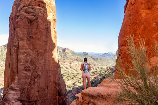 Female hiker looks out onto the view of Sedona Arizona