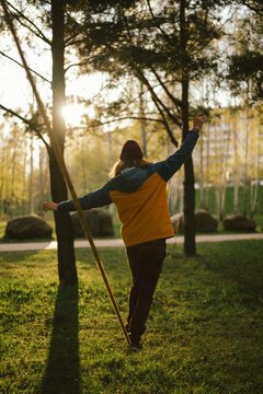 Athletic man trains on a slackline.