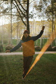 Athletic man trains on a slackline.