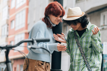 couple looking at mobile phone and arguing