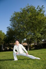 Middle-aged man doing morning exercises in the yard