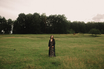 Calm woman enjoying the moment and slow life at her eco-farm. Concept green tourism, slow life, gardening, eco friendly. Part of the series