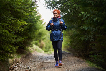 Hiker lady with backpack in the mountains