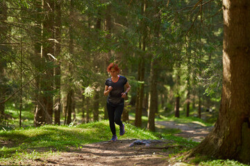 Woman trail runner in the forest - 808651223