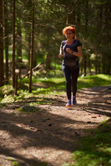 Woman trail runner in the forest - 808651263