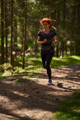 Woman trail runner in the forest - 808651267