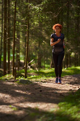 Woman trail runner in the forest - 808651269