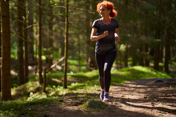 Woman trail runner in the forest - 808651275