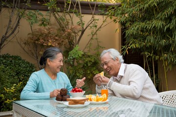 Elderly couples have breakfast in the yard