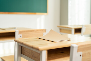 Shot of empty classroom with chairs under desks in elementary school.