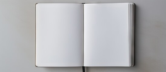 There is an open notebook on a gray background in the copy space image