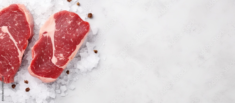 Poster top view of raw pork medallion steaks on a white stone table providing a clean and minimalistic back