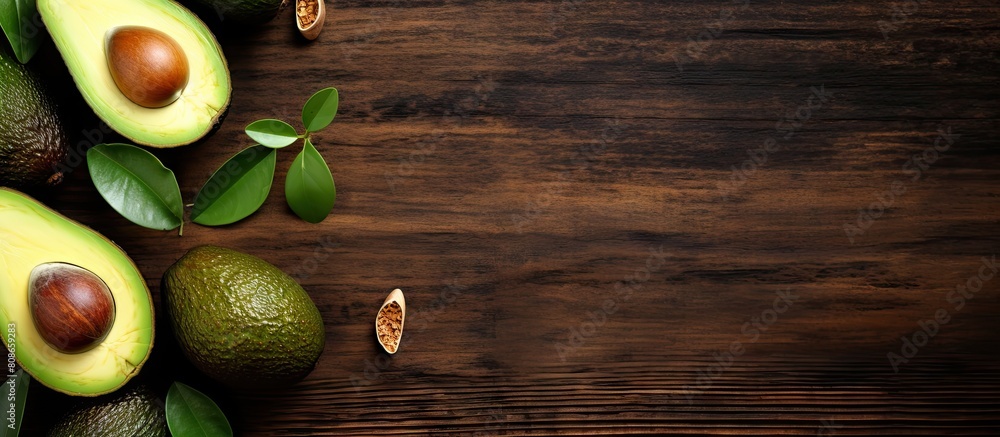 Poster view from above of an old wooden table with a fresh organic avocado on it serving as a background fo