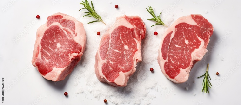 Poster top view of raw pork medallion steaks on a white stone table providing a clean and minimalistic back