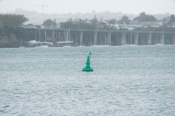 A red buoy floats in the harbor