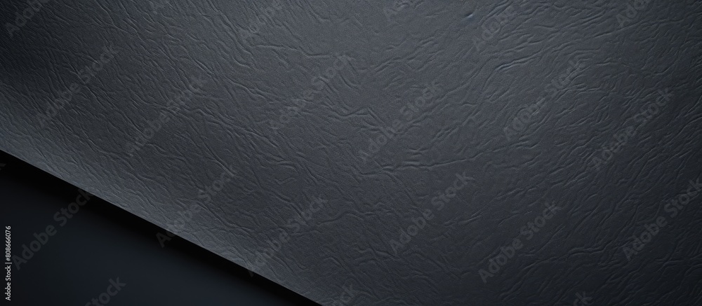 Poster a textured black paper with a sheet like appearance creates a background for copy space images