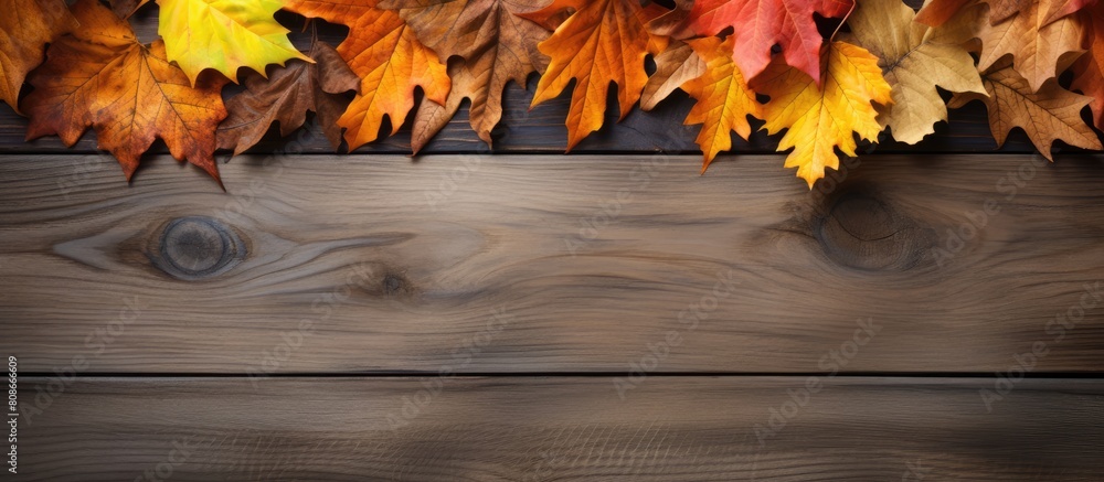 Poster there is a copy space image with autumn leaves forming a frame on a wooden background