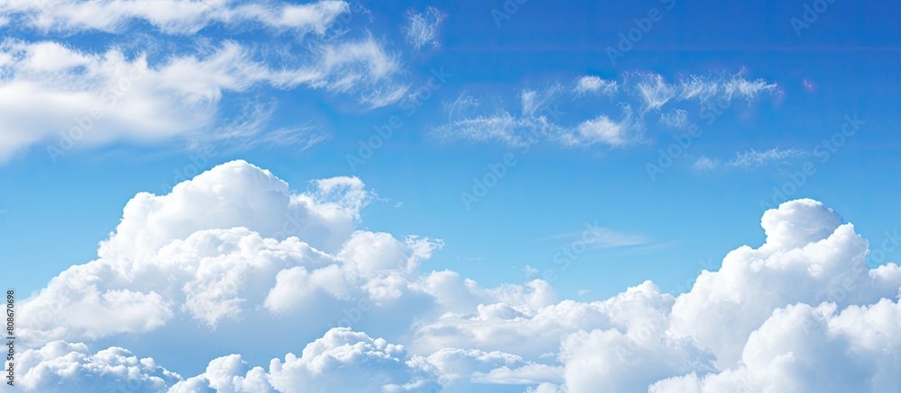 Poster a serene background with a stunning blue sky fluffy white clouds and ample copy space for adding tex