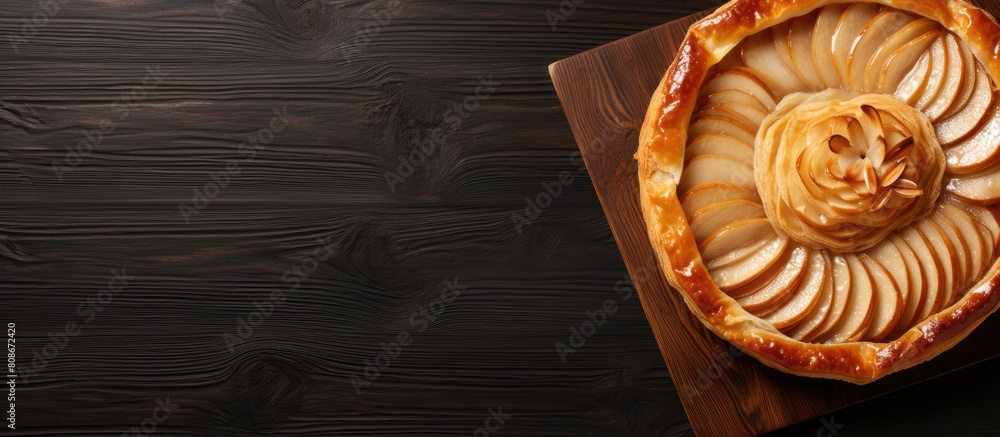 Poster a homemade puff pastry pie with pears displayed on a round cutting board ample copy space available 
