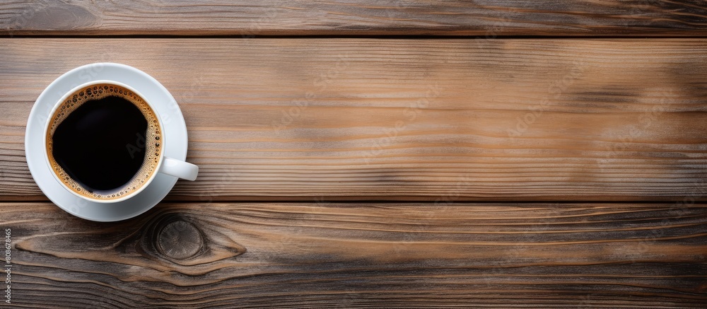 Poster top view of a wooden table with a white cup of espresso coffee and a black cup of hot coffee leaving