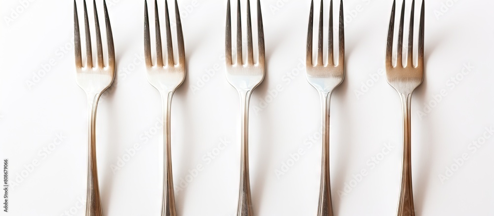 Poster a white background showcases five plastic forks in an isolated arrangement leaving ample copy space 