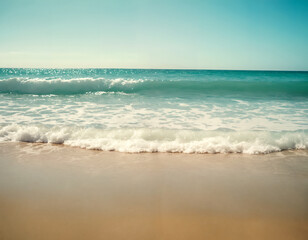 Fototapeta premium Waves on the beach. Gentle waves lapping onto a sandy shore. Clear skies. Summer vibes. Serene and tranquil mood. Natural beauty of an unspoiled beach.