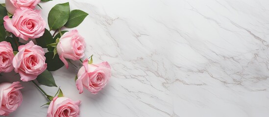 A pink rose bouquet with flower bud framings sits on a white marble table creating a captivating image with copy space It is displayed as a flat lay with a top view representing a nature themed conce