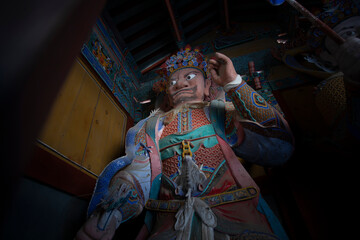 The colorful statue of a guard in Woljeongsa Temple is Located in a forested valley on the eastern side of Odaesan Mountain, South Korea. Korean traditional temple.
