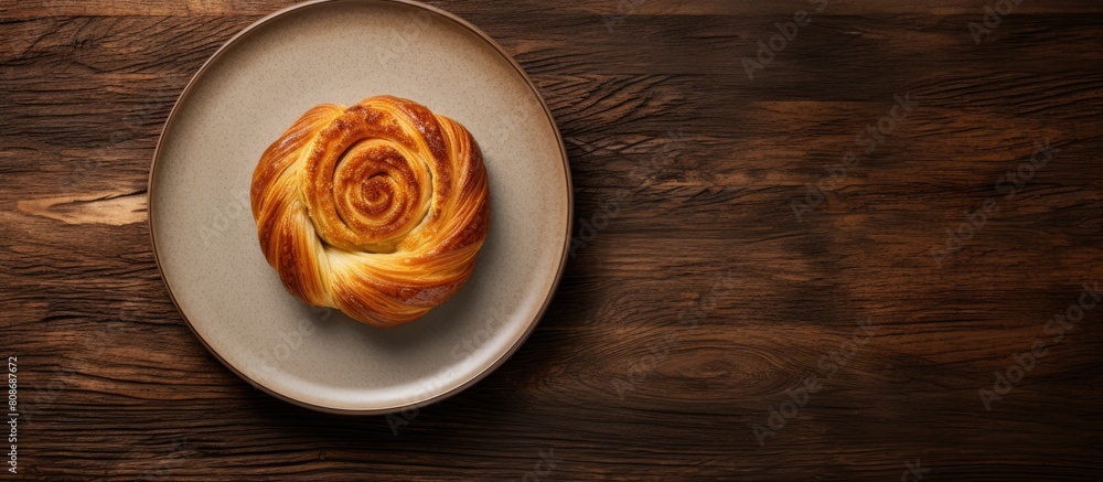 Poster Top view of a plate with a delicious whole wheat baked pastry ready to be enjoyed in a copy space image