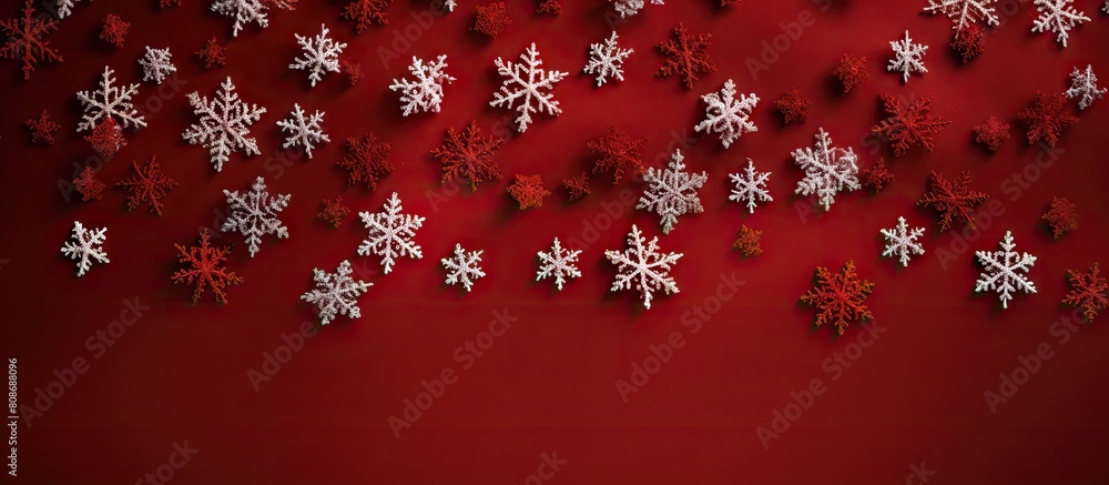 Poster a top down view of christmas snowflakes on a red knitted background with ample space for additional 