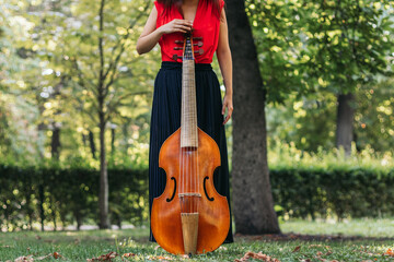 Female musician with her cello outdoors