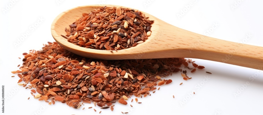 Sticker A photo of flax grains and spices in a wooden spoon placed on a white background with space available for text. Copy space image. Place for adding text and design