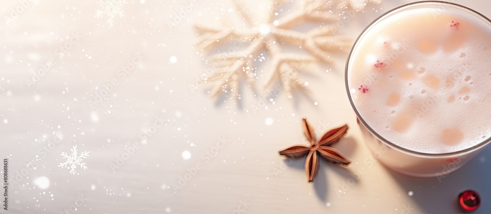 Poster a winter themed beverage adorned with a wooden snowflake and a small red toy ball creating a festive