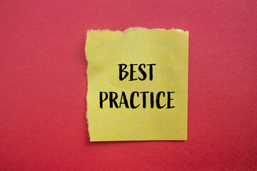 Best practice words written on ripped yellow paper piece with red background. Conceptual best practice symbol. Copy space.