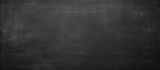 Dark wall backdrop with the texture of chalk on a blackboard or chalkboard creating a school education theme and a concept of learning Copy space image - Powered by Adobe